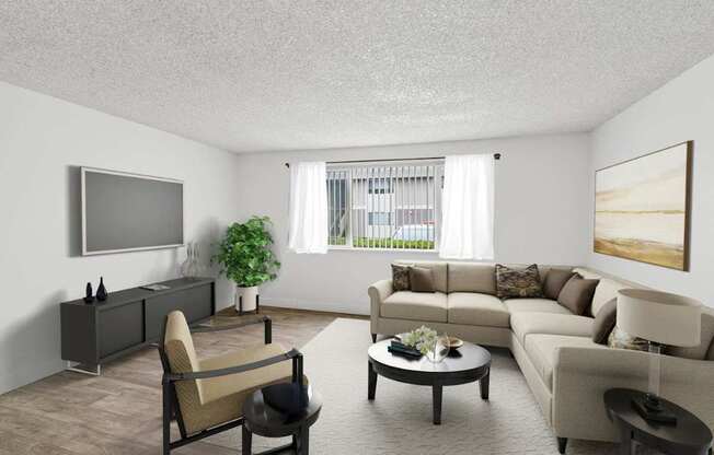 A living room with a grey sofa, a brown armchair, a coffee table, and a flat screen TV mounted on the wall.