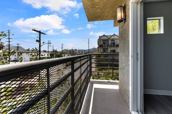 a balcony with a view of the street and buildings at NOHO GALLERY Apartments, North Hollywood , California 