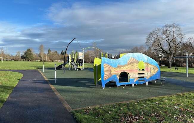 A playground with a slide and a fish-shaped play structure.