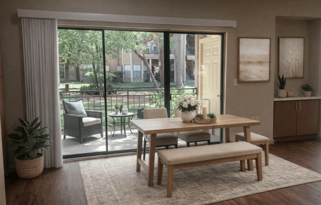A dining room with a table and chairs and a view of a backyard.
