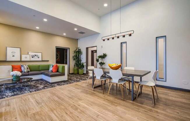 A modern dining area with a wooden table and chairs.