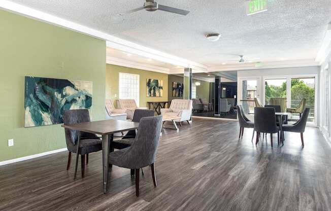a living room and dining room with chairs and a table