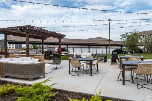 a patio with tables and chairs and a pavilion