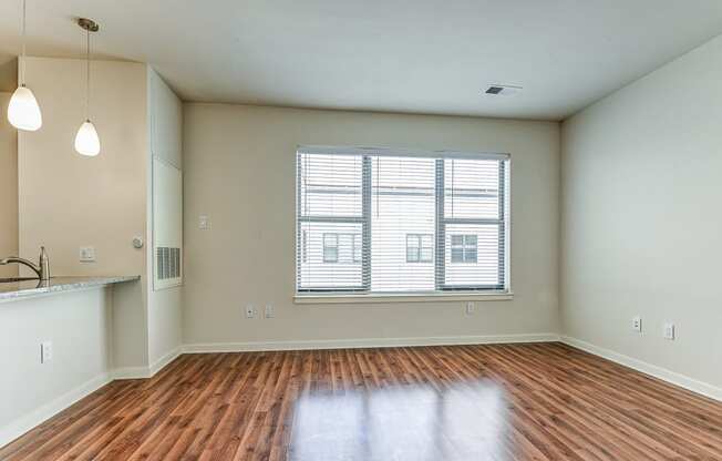 Kitchen and living room with hardwood floors and a large window at The View at Old City, Philadelphia