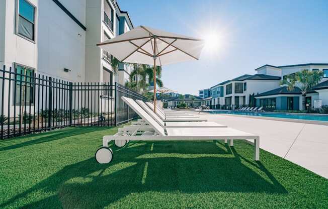 The Pointe on Westshore outdoor community swimming pool with ample lounge chairs in Tampa, FL