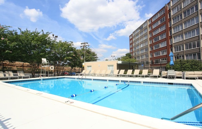 a swimming pool at a hotel in front of a building