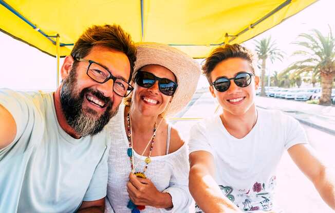 Three people are sitting in a vehicle and taking a selfie at Portofino Vineyards Apartment, Fort Myers, FL, 33967