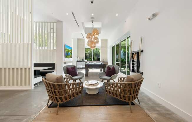 a living room with two chairs and a table and a fireplace