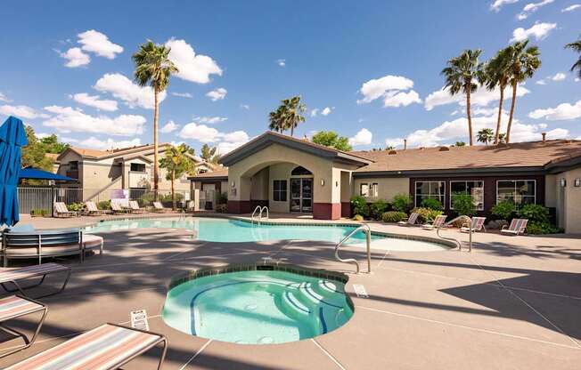 our resort style pool is surrounded by chairs and palm trees