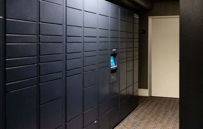 A wall of lockers with a door on the right.