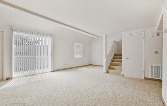 renovated living room with carpet and stairs