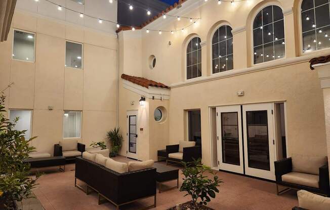 A patio area with a couch, chairs, and a table.