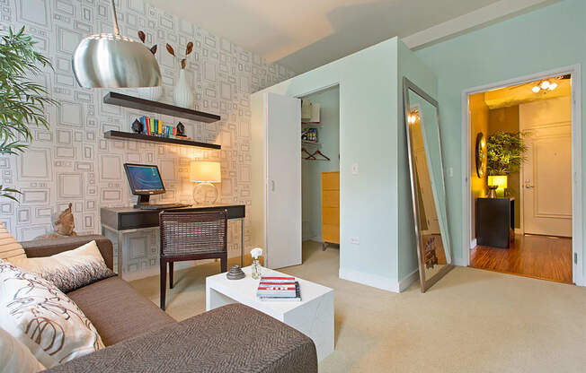 a living room with a couch and a desk