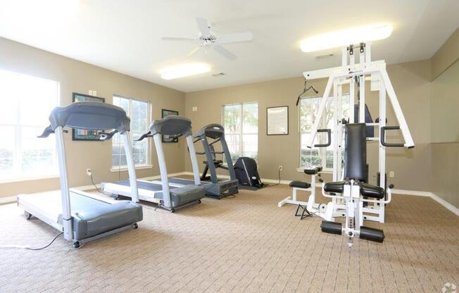 a gym with weights and other equipment in a home gym