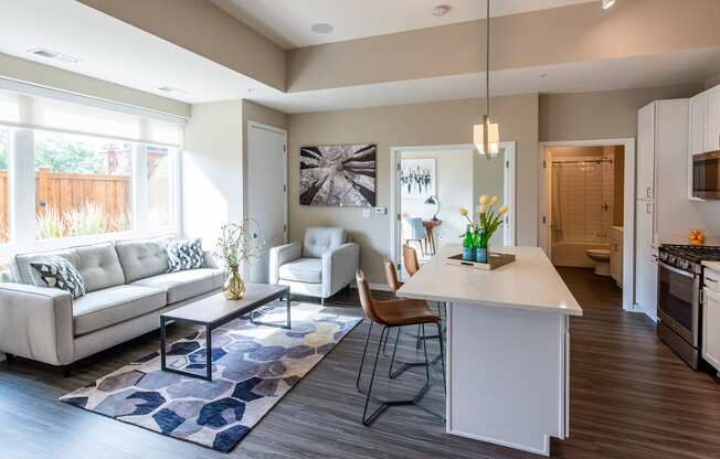 a living room and kitchen with a couch and a table