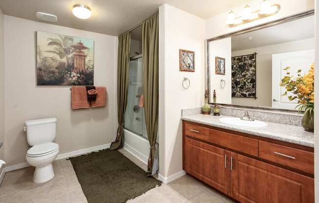 A bathroom with a toilet, sink, and shower.