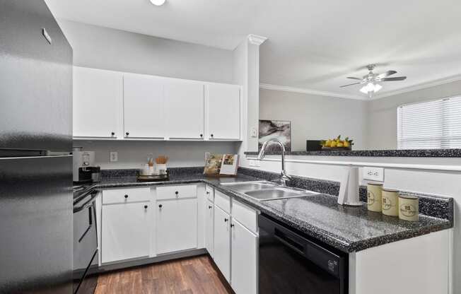 the preserve at ballantyne commons apartment kitchen with granite counter tops and white cabinets