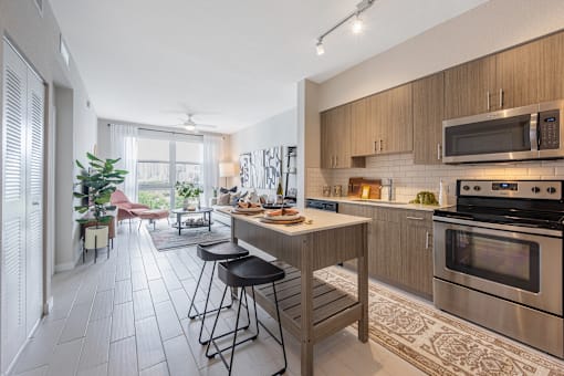 a kitchen with stainless steel appliances and a island with stools