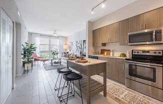 a kitchen with stainless steel appliances and a island with stools