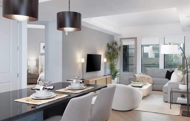 A modern living room with a grey and white color scheme.