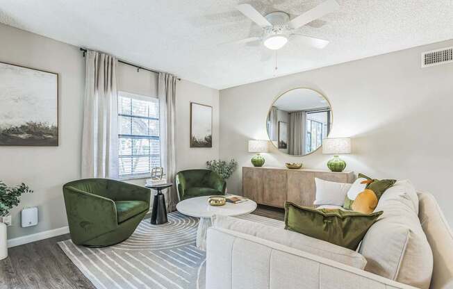 Living room with a white couch and green chairs and a ceiling fan at The Atlantic Preserve, Plantation, FL 33322