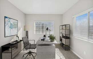 an office with a desk and a chair and a window