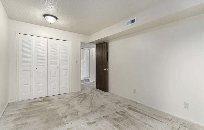 A bedroom with a large closet at West Wind Apartments, Fort Wayne, 46808