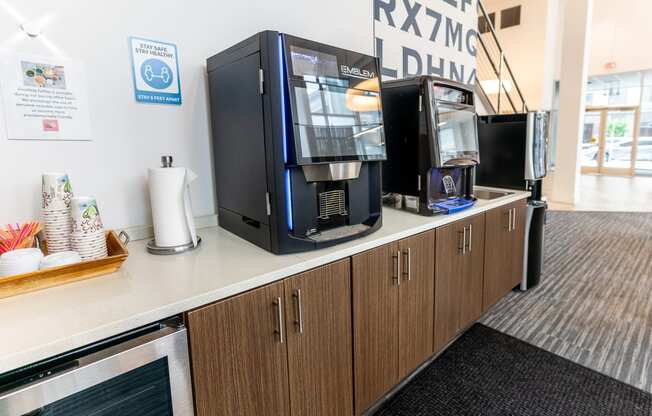 a counter with coffee machines on it in a break room