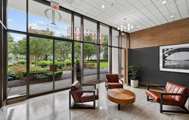 A waiting room with leather chairs and a view of the outside.