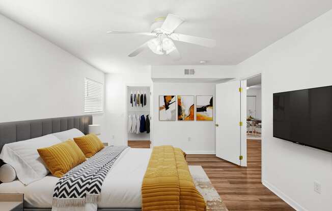 a bedroom with a large bed and a ceiling fan