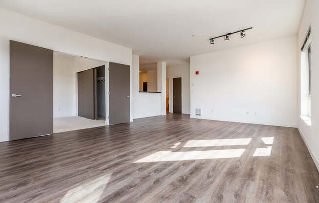 A room with wooden floors and white walls.