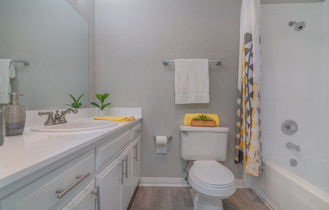 a white bathroom with a toilet and a sink at Citra Apartments LLC, California, 92107