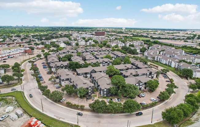 A large roundabout with a lot of traffic and buildings around it.