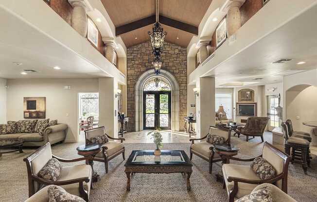 A large, well-furnished living room with a chandelier and a fireplace.