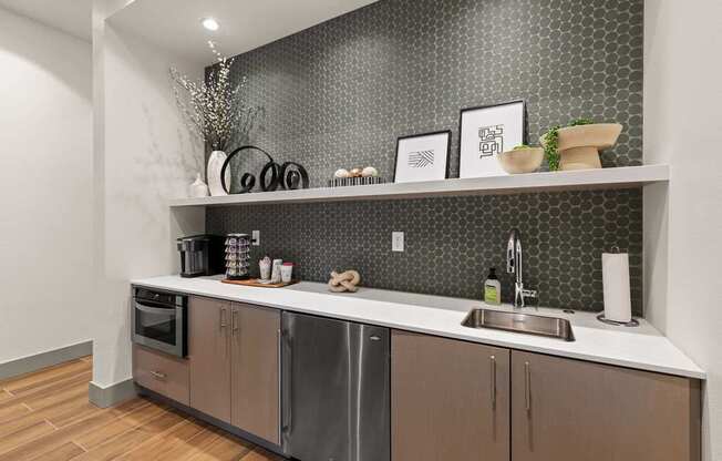 A modern kitchen with a stainless steel dishwasher and wooden cabinets.