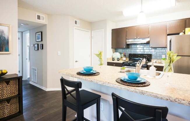 a kitchen with a plates and cups on a counter top at Eclipse Duluth