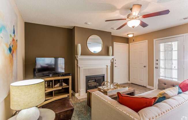 A living room with a fireplace and a television.