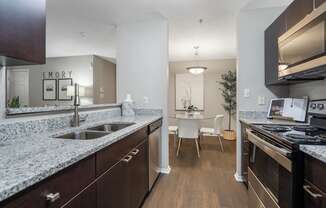 A kitchen with granite countertops and stainless steel appliances.