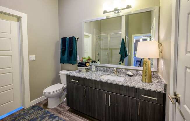 Harmony Luxury Apartments large bathroom with wooden floors