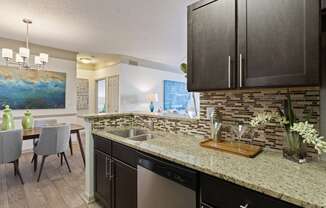 Kitchen with Granite Countertops and Backsplash located at St. Andrews Apartments in Johns Creek, GA 30022