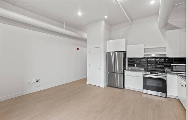 A modern kitchen with white cabinets and stainless steel appliances. at Brickside Heights, Millcreek, 84106