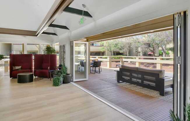 a living room with sliding glass doors to a patio at Summerwood Apartments, Santa Clara, California