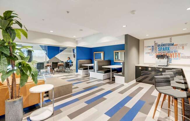 A modern office space with a blue and grey carpet.