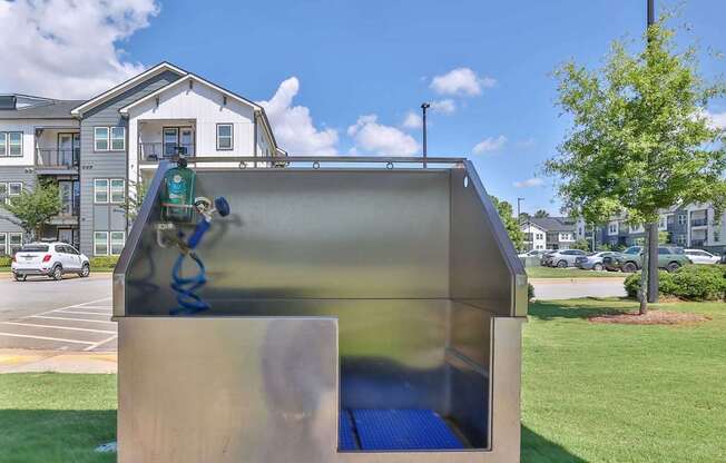 A playground with a slide and a blue mat.