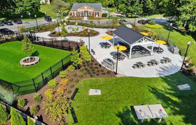 a community park with a games, firepit, dog park and a pavilion