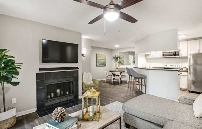A modern living room with a fireplace and a flat screen TV.
