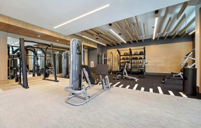 a gym with weights and exercise equipment in a building