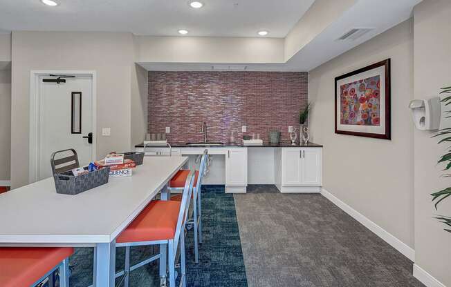 a dining room with a long table and chairs and a brick wall