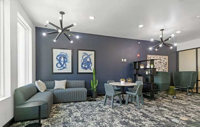 a living room with blue walls and a table and chairs