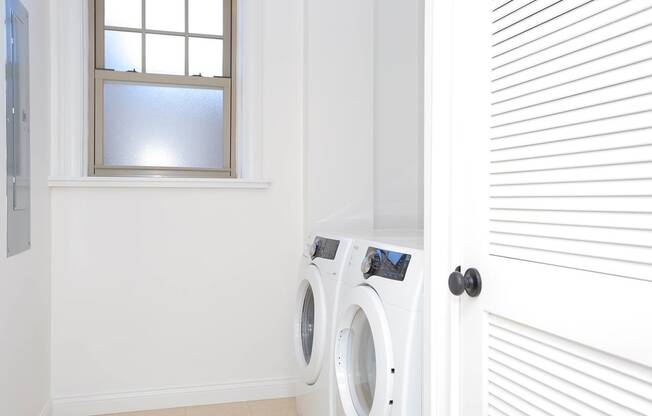 laundry room with side-by-side white washer and dryer at York House, Missouri, 63108